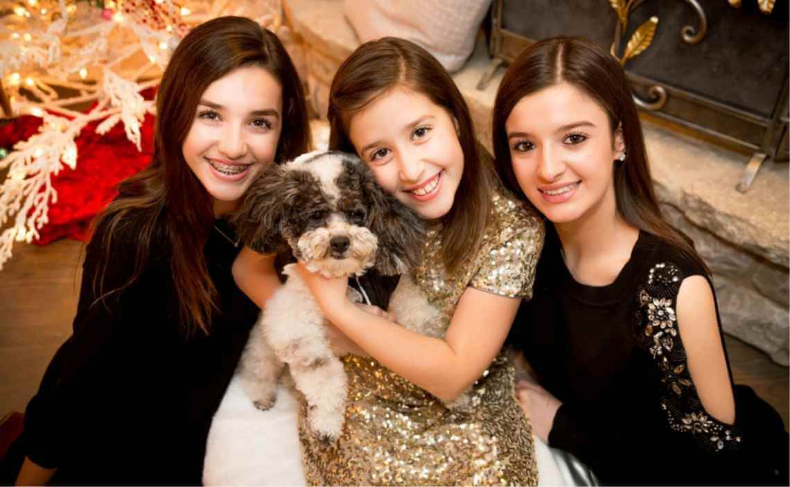 girls with fluffy dog Christmas dress up