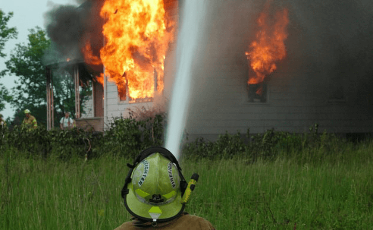 fireman putting out house fire