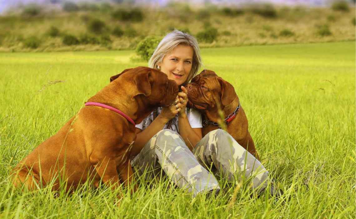 older female dog owner with two large breed dogs
