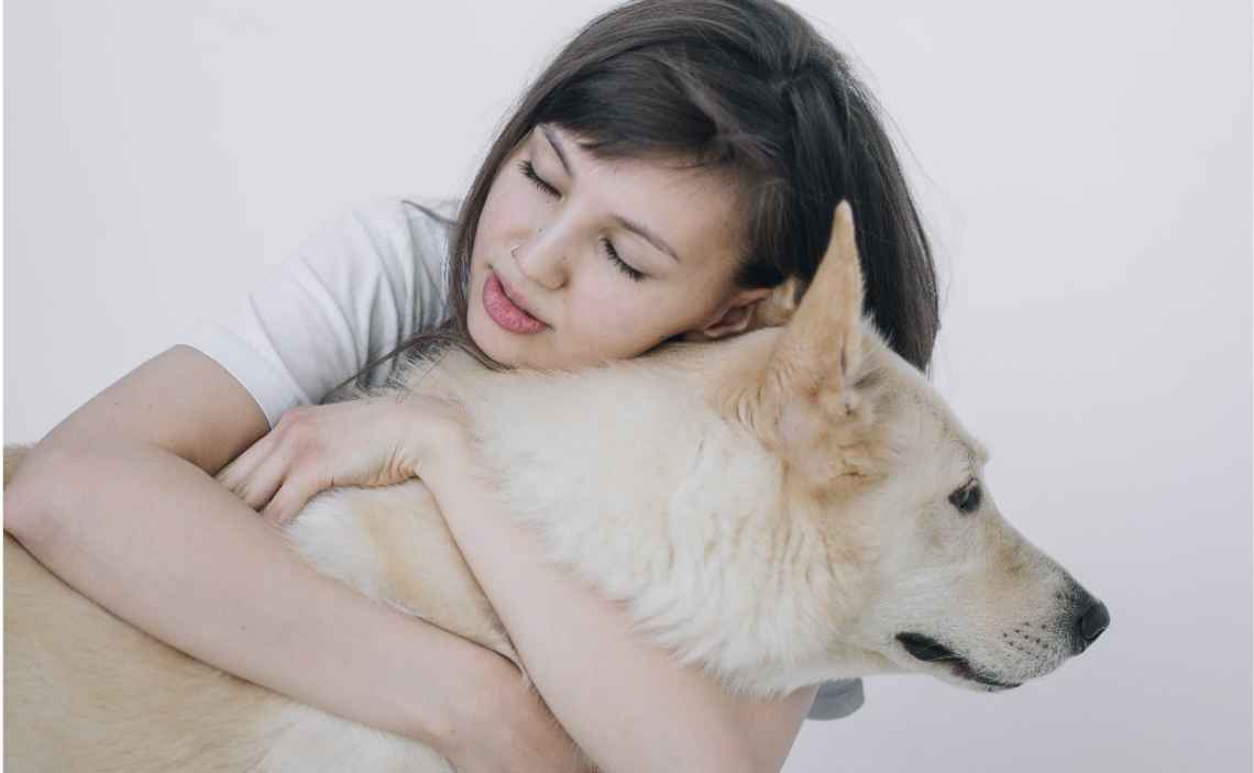 WOMAN HUGGING DOG