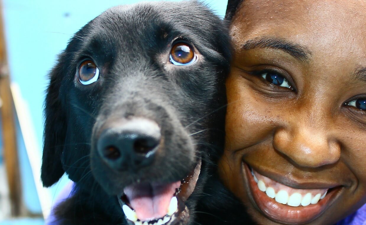 happy woman with black and white dog