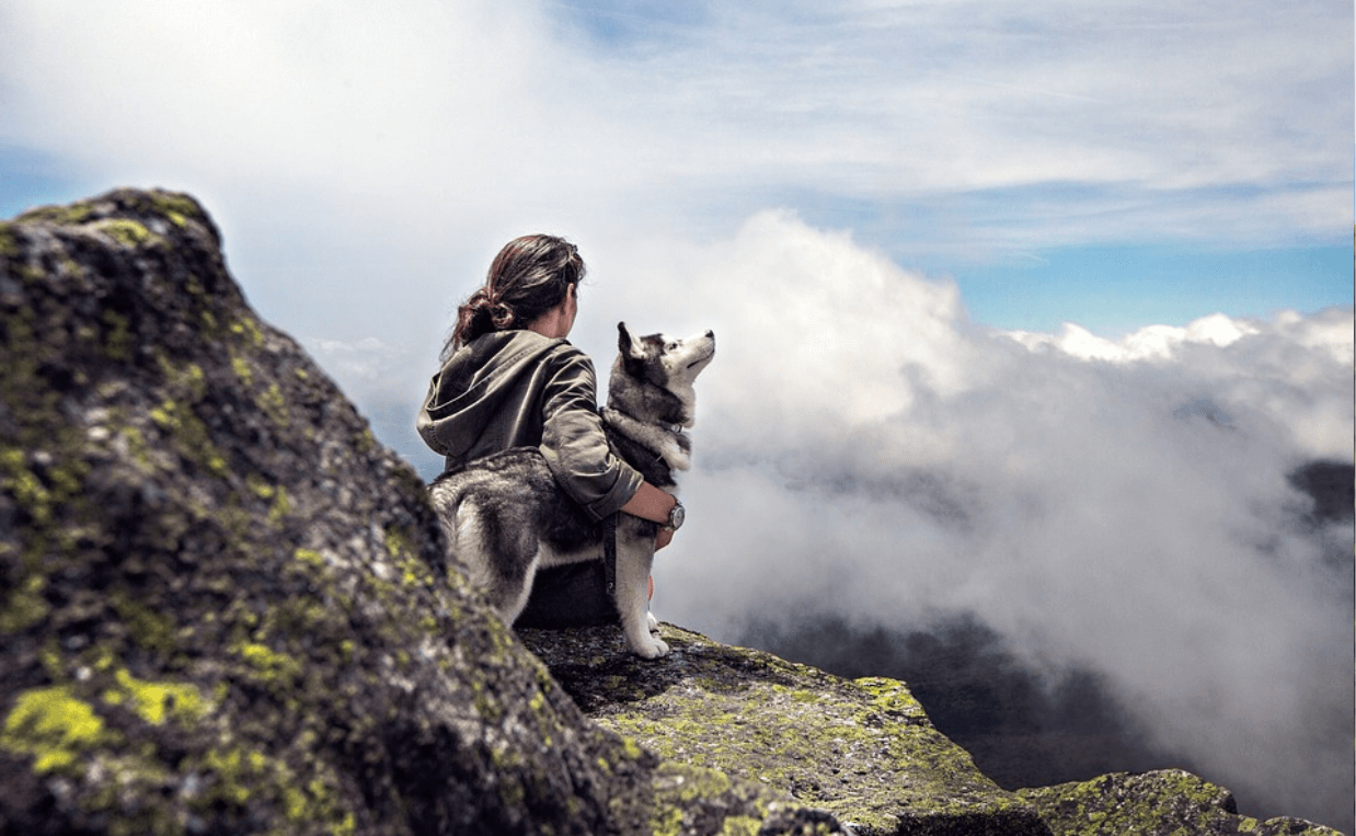 DOG AND WOMAN IN MOUNTAINS