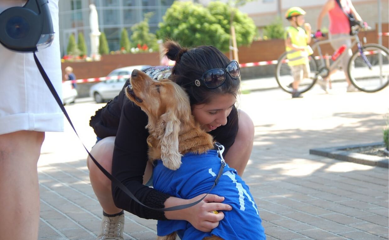 WOMAN HUGGING SERVICE DOG