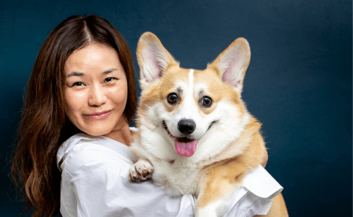 WOMAN HOLDING AN AKITA