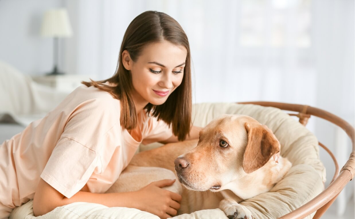 WOMAN GIVING DOG AFFECTION