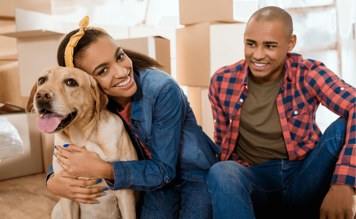 happy couple moving with dog