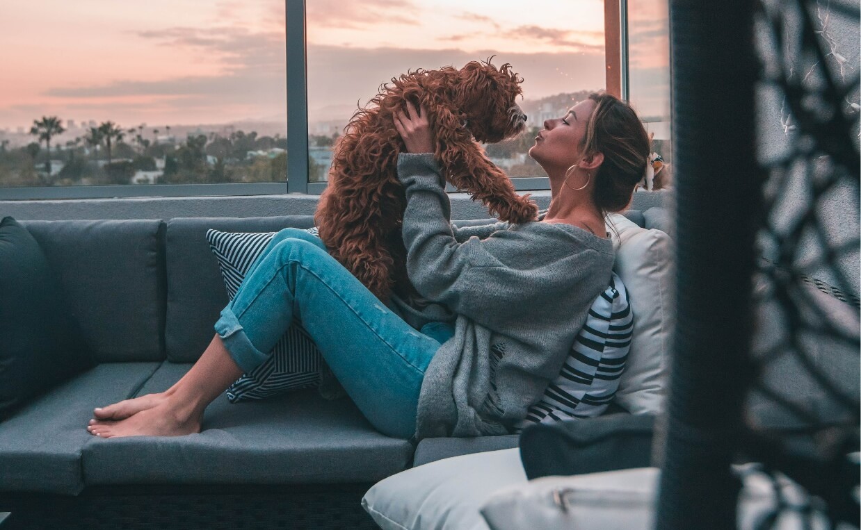 DOG-FRIENDLY TRAVEL ACCOMMODATIONS - woman on terrace with poodle