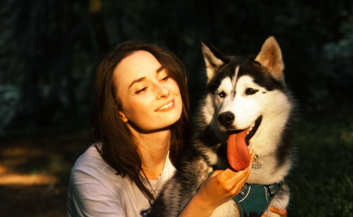 WHAT COLORS CAN DOGS SEE - WOMAN WITH HUSKY DOG