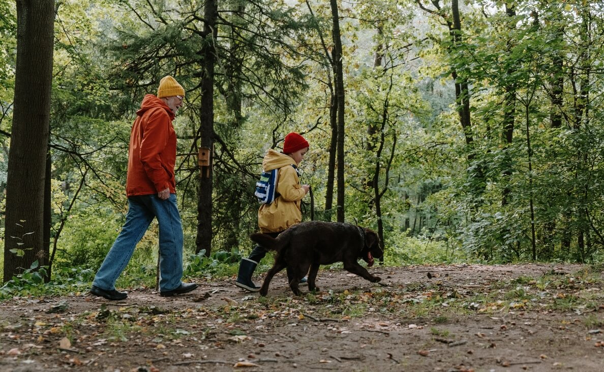 ENVIRONMENTAL ENRICHMENT - black lab hiking with boy and grandpa