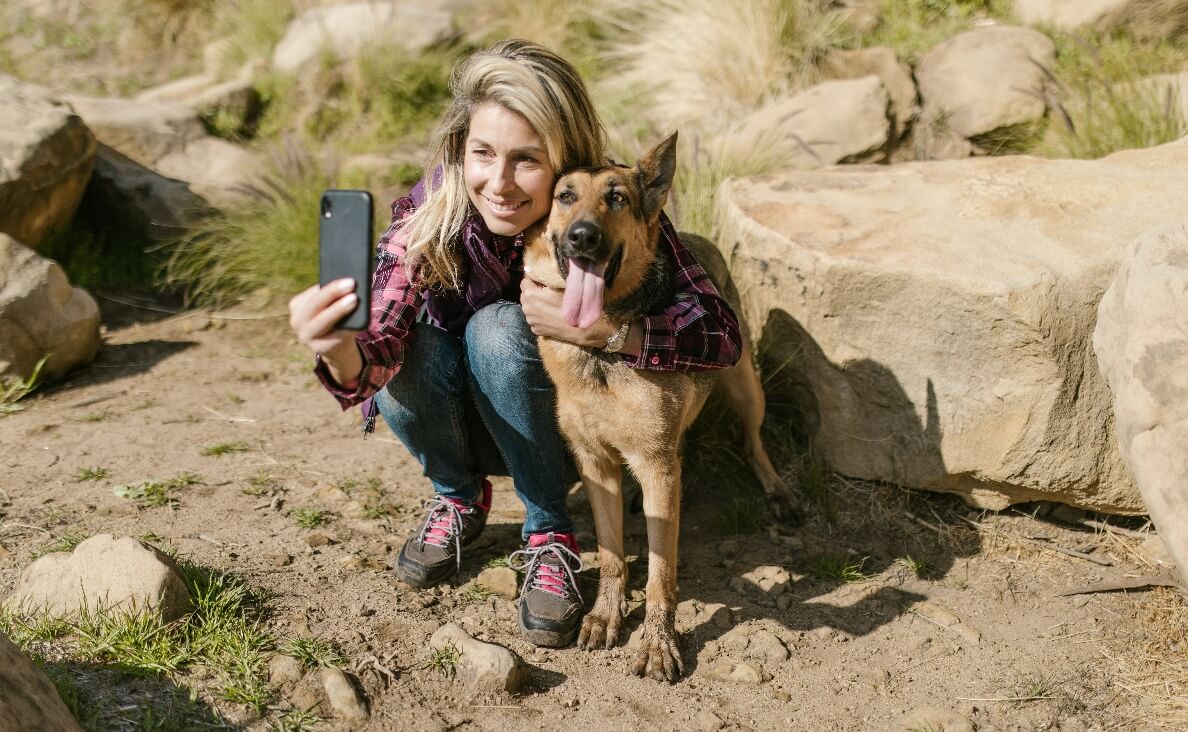 ENVIRONMENTAL ENRICHMENT - german shepherd hiking with woman taking a selfie with the dog