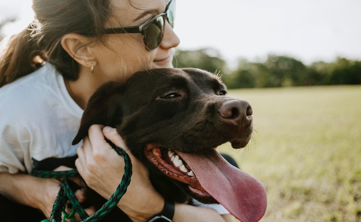 5 LOVE LANGUAGES - woman next to chocolate lab